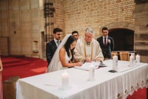 Sydney Wedding - a bride and groom sign their marriage certificate