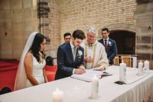 Sydney Wedding - a bride and groom sign their marriage certificate