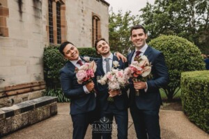 Sydney Wedding - groomsmen pose with the bridal bouquets outside the church