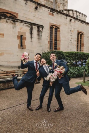 Sydney Wedding - groomsmen pose with the bridal bouquets