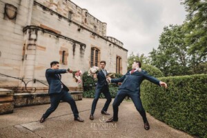 Sydney Wedding - groomsmen pretend to swordfight with the bridal bouquets