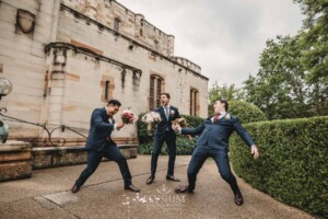 Sydney Wedding - groomsmen pretend to swordfight with the bridal bouquets
