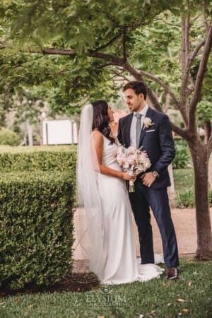 Sydney Wedding - newlyweds pose in the church gardens after the ceremony