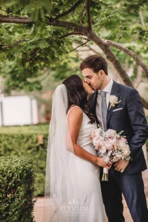 Sydney Wedding - newlyweds kiss in the church gardens after the ceremony