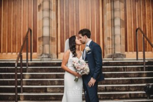 Sydney Wedding - bride and groom kiss on the church steps after the ceremony