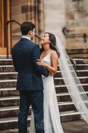 Sydney Wedding - bride and groom embrace on the church steps after the ceremony