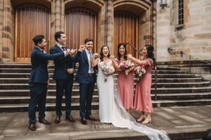 Sydney Wedding - the bridal party stand on the church steps after the ceremony