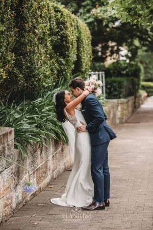 Sydney Wedding - bride and groom embrace each other on the footpath after the ceremony