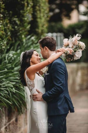 Sydney Wedding - bride and groom embrace each other on the footpath after the ceremony