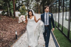 Sydney Wedding - bride and groom walk along a path in the gardens at Springfield House