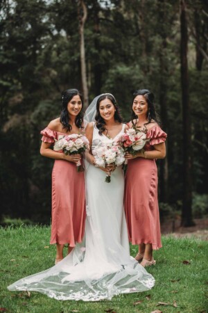 Sydney Wedding - a bride stands with her bridesmaids in the gardens at Springfield House
