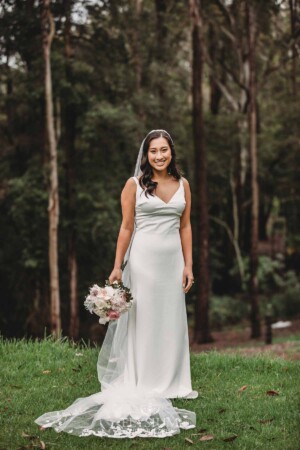 Sydney Wedding - a bride stands against the bush backdrop at Springfield House