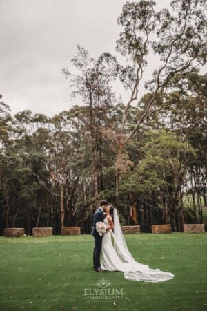 Sydney Wedding - a bride and groom hug in the trees at Springfield House