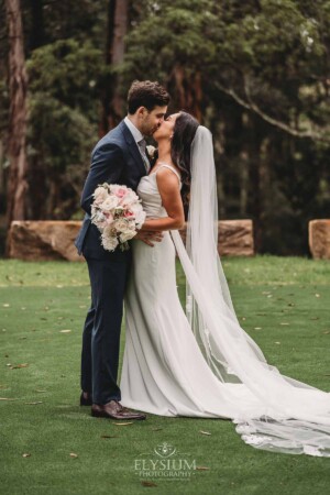 Sydney Wedding - a bride and groom kiss in the trees at Springfield House