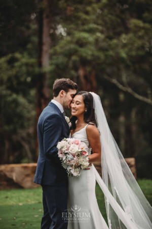 Sydney Wedding - a groom kisses his bride's cheek in the gardens at Springfield House