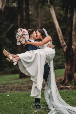 Sydney Wedding - a groom picks up his bride and kisses her at Springfield House
