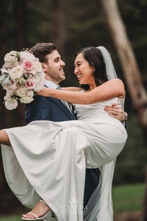 Sydney Wedding - a groom picks up his bride and spins her about at Springfield House