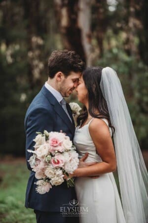 Sydney Wedding - a bride and groom hug in the trees at Springfield House