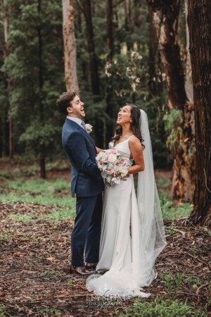 Sydney Wedding - a bride and groom laugh amongst the trees at Springfield House