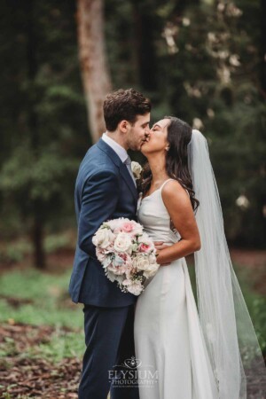 Sydney Wedding - a bride and groom kiss in the gardens at Springfield House