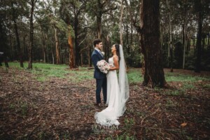 Sydney Wedding - a bride and groom hug in the trees at Springfield House