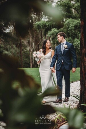 Sydney Wedding - bride and groom walk along a path in the gardens at Springfield House