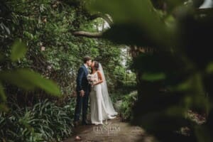 Sydney Wedding - bride and groom share a kiss in the gardens at Springfield House