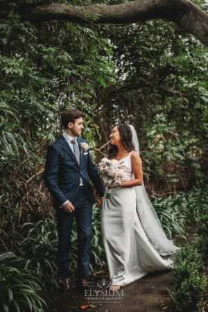 Sydney Wedding - bride and groom walk along a path in the gardens at Springfield House