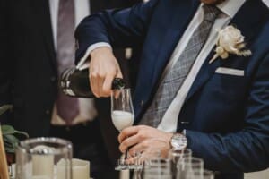 Sydney Wedding - the groom pours a glass of champagne to toast