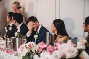 Sydney Wedding - groom laughs during his parent's speech during the reception