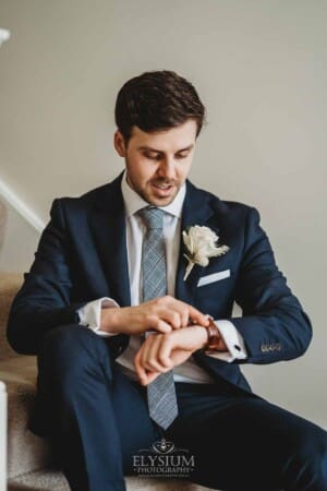 Sydney Wedding - a groom checks his watch before leaving for the ceremony
