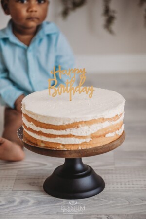 A first birthday cake waiting to be smashed by a baby boy