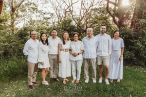 Parents stand with their adult children cuddled around them