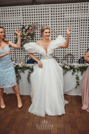 A bride dances with wedding guests during the reception party