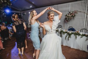 A bride dances with a wedding guest in the Burnham Grove Marque