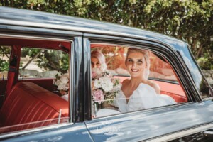 A bride arrives at her Camden wedding venue in a black car