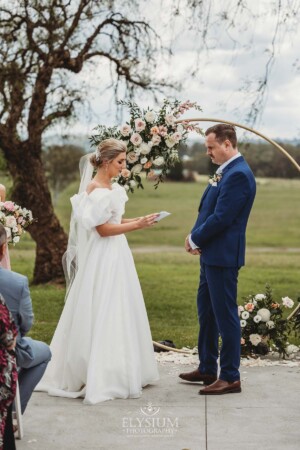 A couple exchange vows during their wedding ceremony at Burnham Grove