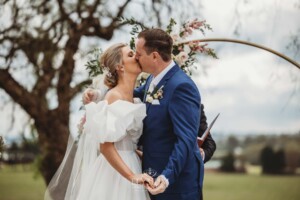 A couple exchange their first kiss during their wedding ceremony in Camden