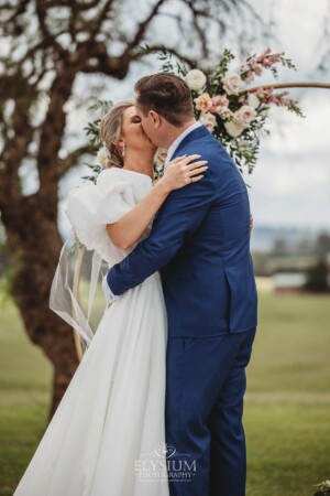 A couple exchange their first kiss during their wedding ceremony in Camden