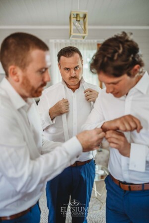 The groom gets dressed at Burnham Grove before the wedding