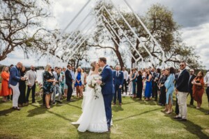 A couple kiss at the end of the aisle after their Camden wedding ceremony