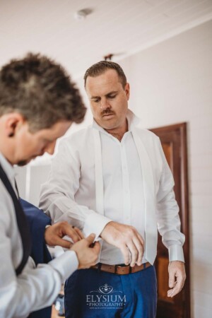 The groom gets dressed at Burnham Grove before the wedding