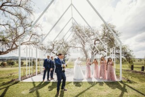 The bridal party pop a champaign bottle and shake it after the wedding ceremony