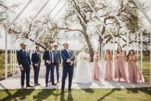 The bridal party pop a champaign bottle and shake it after the wedding ceremony