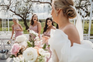 A bridesmaid laughs as they celebrate after the ceremony