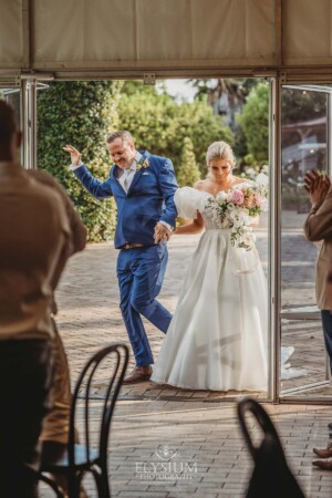 The bride and groom dance as they enter the reception marque at Burnham Grove