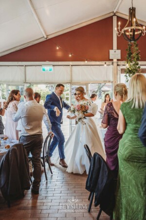 A bride and groom dance as they enter the reception marque at Burnham Grove