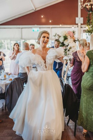 A bride dances her way into the wedding reception marque