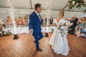 A bride and groom dance their way into the wedding reception at Burnham Grove