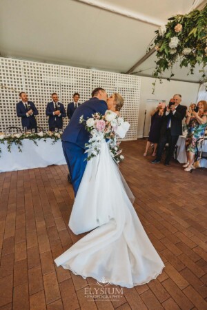 A bride and groom hug as they enter their Burnham Grove wedding reception